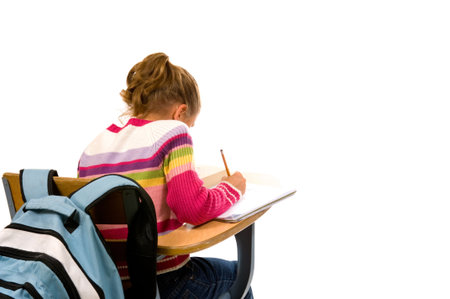 Young female student doing school work at desk with backpack on white background
