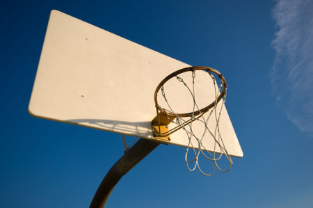 Basketball hoop and net with blue sky background