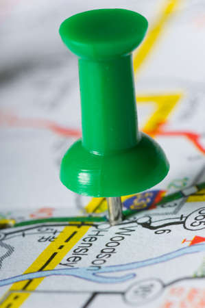 Pushpin on map pinpointng a particular area, map in not distinguishableの写真素材