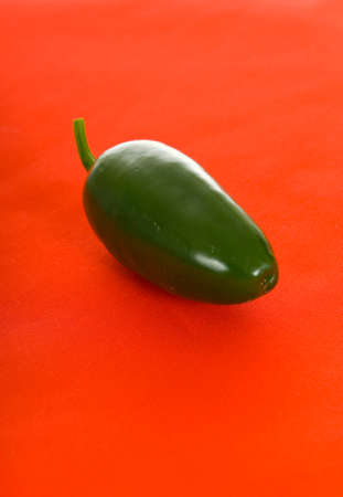 Spicy jalapeno pepper on red tableclothの写真素材