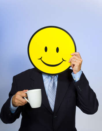 Smiley face man drinking a cup of coffee - の写真素材