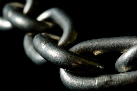 Macro shot of links of a chain - great for background - symbol of binding or bondage