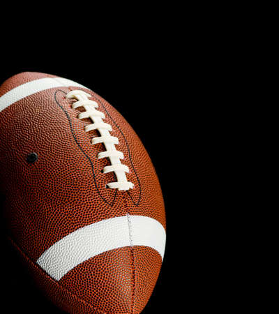 Brown leather american football on black backgroundの写真素材