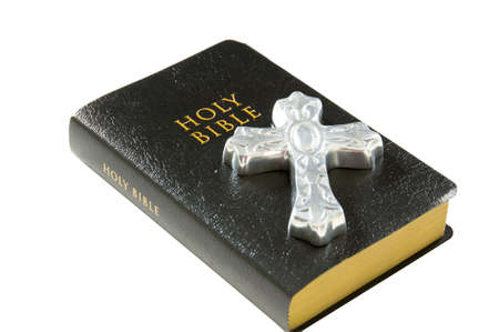 Silver cross lying on top of a black leather bibleの写真素材