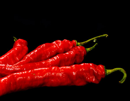 Red Hot chili peppers on black background