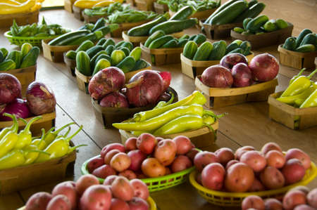 Farmers's Market with fresh produce including onions, peppers, potatoes, cucumbers and squashの写真素材