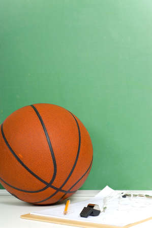 Items used by a basketball coach including a ball and a black board with copy spaceの写真素材