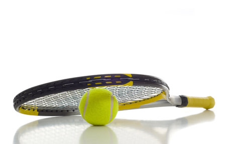 Tennis ball and racket on white background with copy space