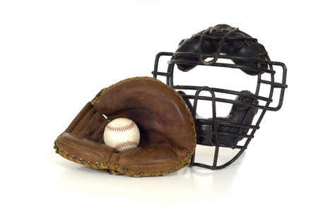 Baseball Catcher's gear on white background including a mitt, ball and face maskの写真素材