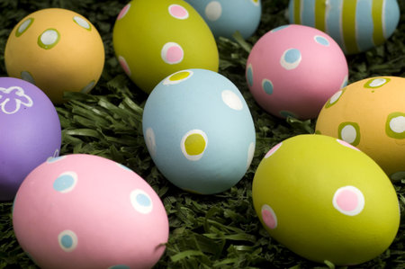 A group of brightly colored easter eggs on green grass