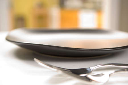 Dinnerware setting with black plates and flatwareの写真素材