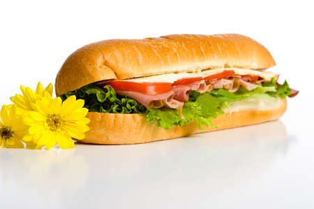 A beautiful  meat, lettuce, tomato and cheese sandwich on a white backgroundの写真素材
