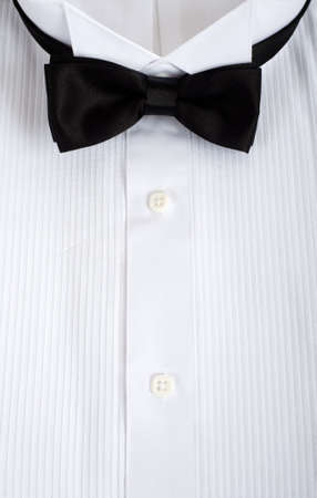 A backgound consisting of a tuxedo shirt with a black silk tie with copy space, formal attire for wedding or waiter or service personellの写真素材