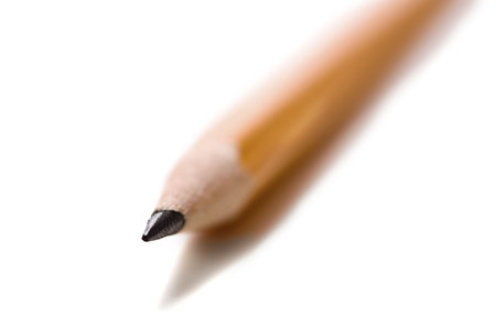 A macro of  a yellow school pencil with very, very shallow depth of field on a white backgroundの写真素材