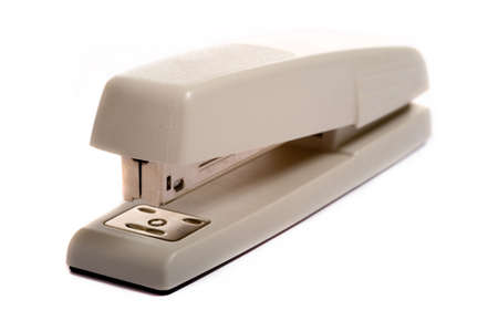 A brown office stapler on a white background with copy spaceの写真素材
