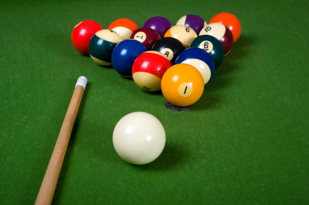 A set of billiards or pool balls on a green flet table with copy space