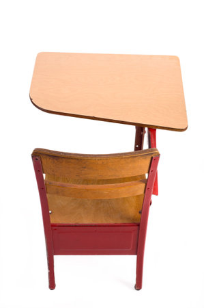 A empty, red, vintage school desk on a white background with copy space