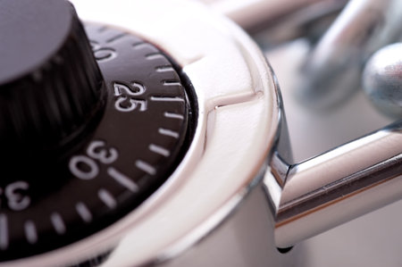 A combination lock and a silver chain on a white background with copy space, security concept
