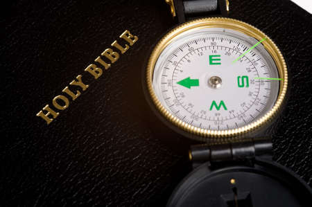 An engineers directional compass on a Bible, concept of guidance or directionの写真素材