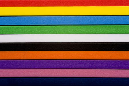 A stack of colorful foam forming a mulit-colored  striped backgroundの写真素材