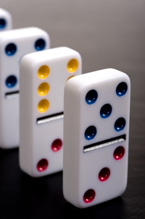 Dominos lined up in a row on a grey backgroundの写真素材