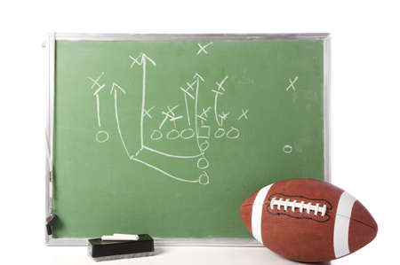 A diagram of a football play on a chalkboard with a football, chalk, eraser ane a whistleの写真素材