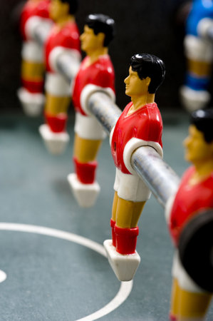 a row of foosball or table soccer playing pieces