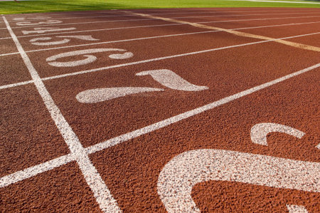 The running lane markers on a running track creating a track and field background