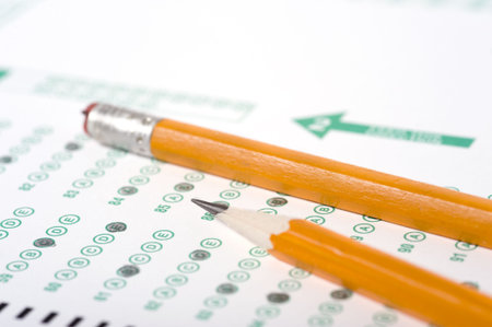 A yellow pencil on a computer read examination or test