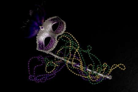 A Mardi Gras or constume party mask with beads on a black backgroundの写真素材
