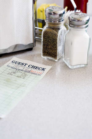 A cafe or restaurant table top background with salt and pepper shakers, napkin holder, guest check etc,の写真素材