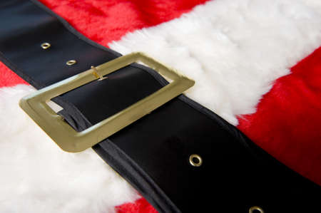 A Santa Claus costume background with red furry suit and a black belt, Christmas or holiday themeの写真素材