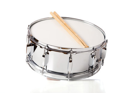 A new silver snare drum with sticks on a white background