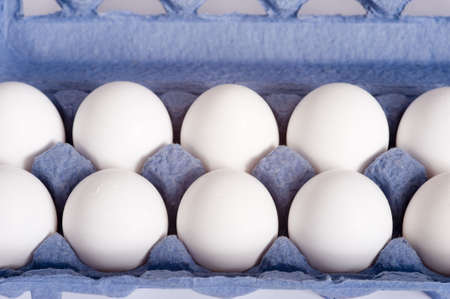 A blue carton of white farm fresh eggsの写真素材