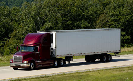 A 18-wheel truck on a highway, transportation industry の写真素材