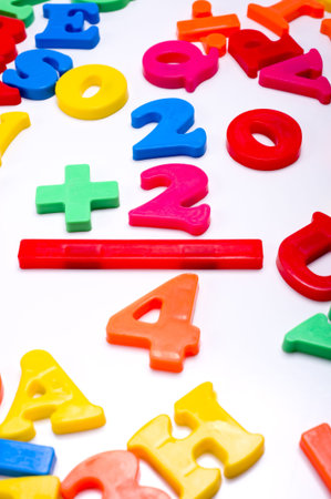 Brightly colored plastic letters on a white background -numbers - Mathematics