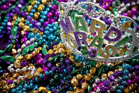 A colorful mardi gras crown or tiara lying on top of beads, holiday themeの写真素材