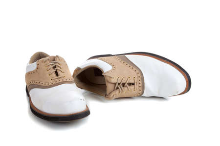 A pair of golf shoes on a white background with copy spaceの写真素材
