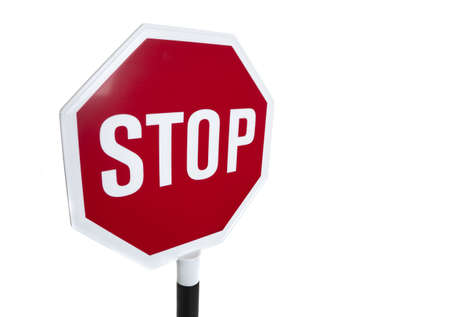A wide angle view of a red "stop" sign on a white backgroundの写真素材