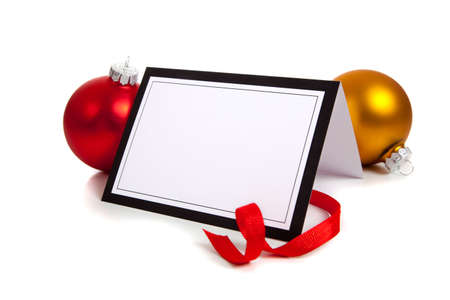 A Christmas themed notecard or message surrounded by baubles and ribbon.  Use as invitation or announcement, with copy spaceの写真素材