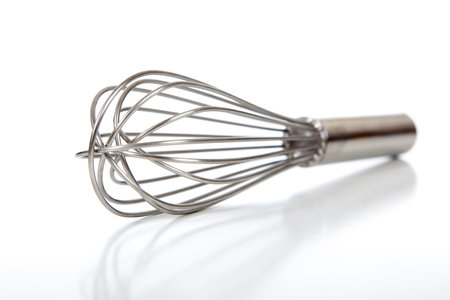 A professional kitchen whisk or whip on white background