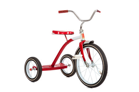A red toy tricycle on a white background with copy spaceの写真素材