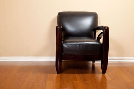 An empty modern black leather chair in a house with copy spaceの写真素材