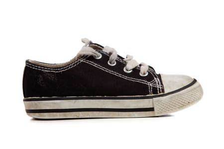 A young childs tennis shoes on a white background with copy spaceの写真素材