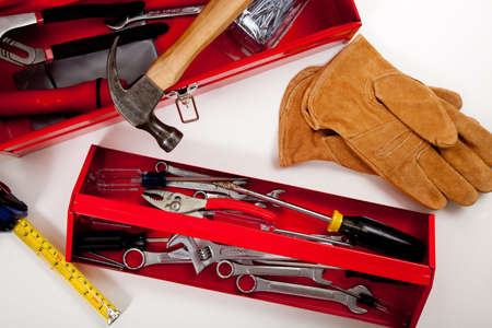 A handyman's tool box with assorted tools including hammer, measuring tape, pliers etc.  の写真素材