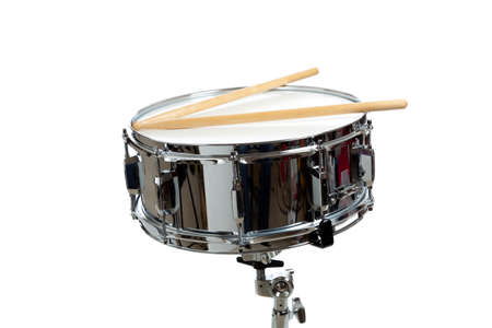 A snare drum with drum sticks on a white backgroundの写真素材