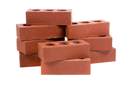 A stack of red bricks on a white background with a pointing trowelの写真素材