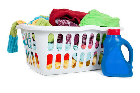 an overflowing laundry basket with a bottle of soapの写真素材