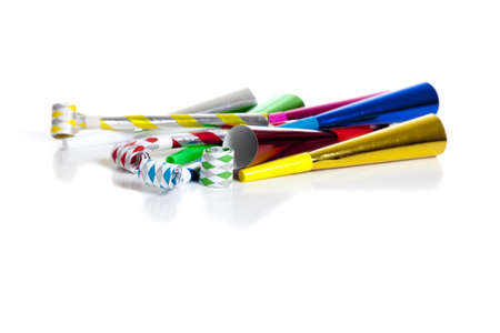 A group of colorful party noise makers, including horns etc. , on a white background with copy spaceの写真素材
