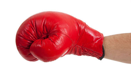 A close-up of a persons arm throwing a punch with a red boxing glove on a white backgroundの写真素材